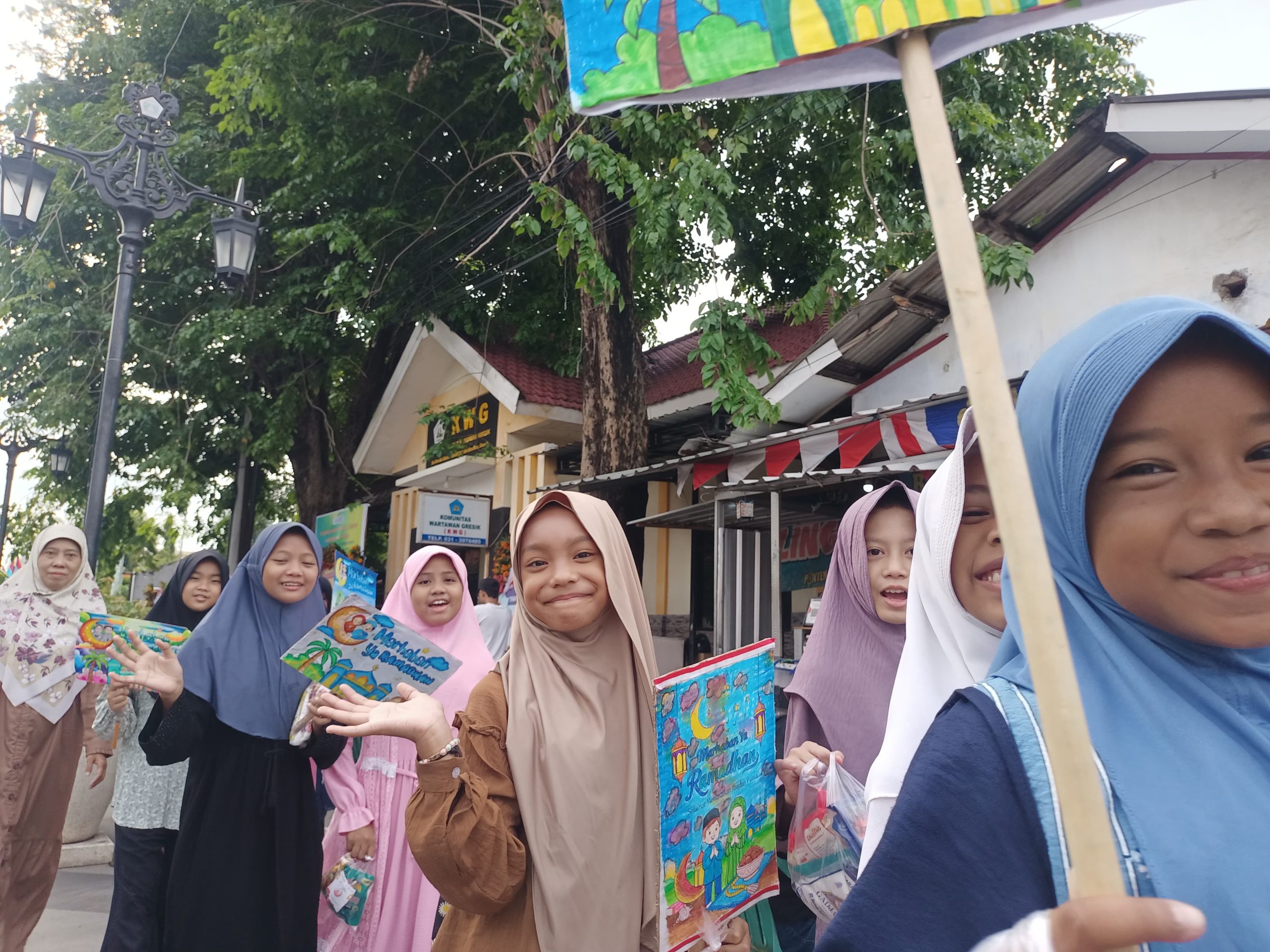 Siswa SD Mugres Kampus B menyambut Ramadan 1447 dengan kirab ceria di Kota Tua Gresik. Mereka membagikan sembako sebagai wujud kepedulian sosial bagi masyarakat sekitar sekolah.